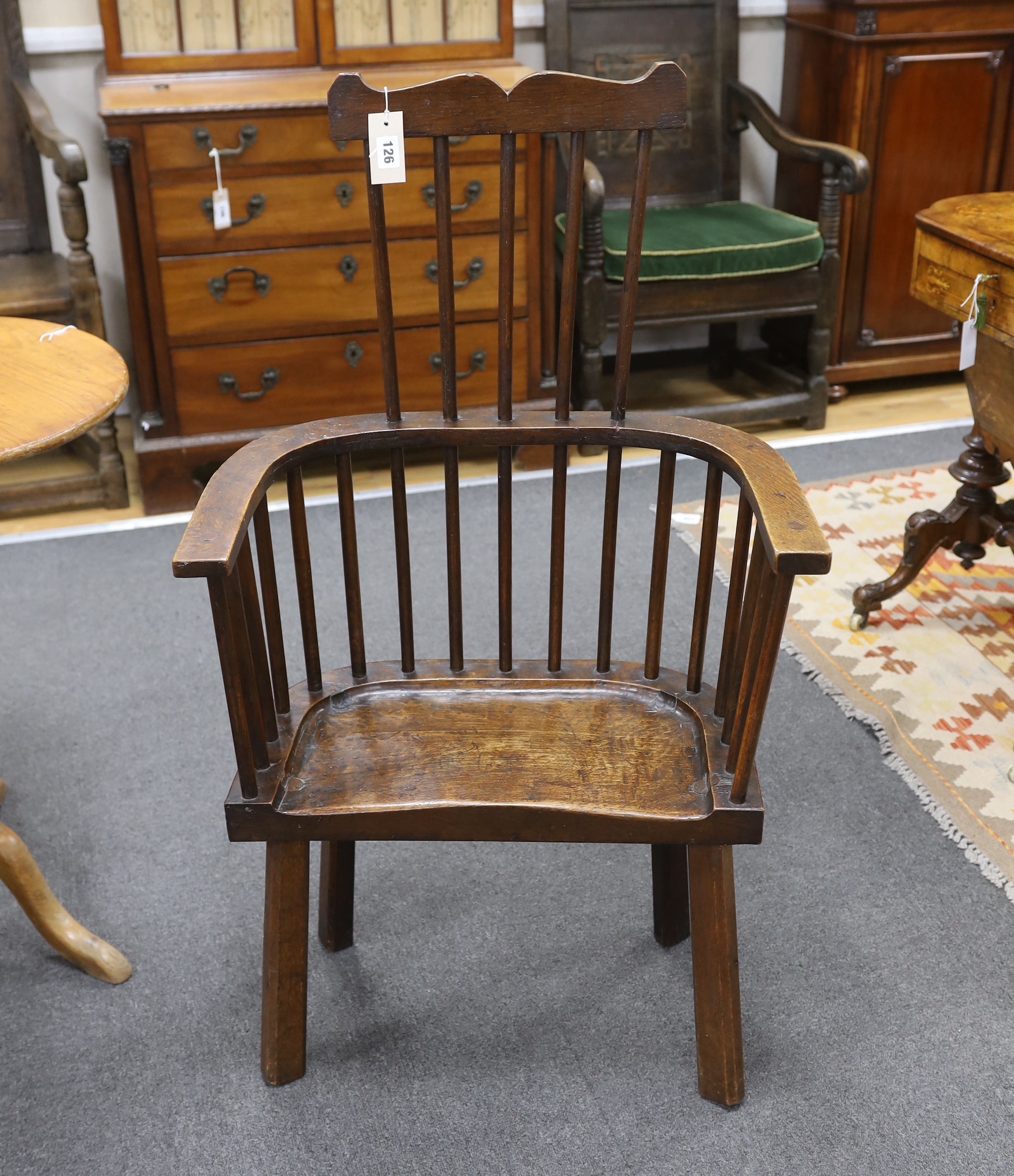 An 18th century-style primitive oak Windsor armchair believed to have been constructed from oak timbers salvaged from re-roofing works at Winchester Cathedral, width 59cm, depth 30cm, height 104cm